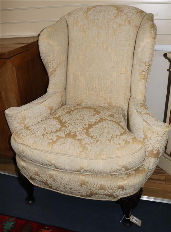 A Queen Anne style carved walnut wing chair